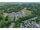 Aerial view of a school with a playground, ballfield, and parking lot in a residential area at 2305 Blueberry St, Belmont, NC 28012