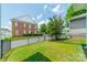 Backyard with a black metal fence and lawn at 2305 Blueberry St, Belmont, NC 28012