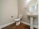 Half-bath with stylish pedestal sink and hardwood flooring at 2305 Blueberry St, Belmont, NC 28012
