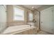 Modern bathroom featuring a soaking tub and a glass-enclosed shower at 2305 Blueberry St, Belmont, NC 28012