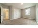 Carpeted bedroom with double doors and a view into the bathroom at 2305 Blueberry St, Belmont, NC 28012