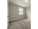 Cozy carpeted bedroom featuring a window that allows ample sunlight to illuminate the room at 2305 Blueberry St, Belmont, NC 28012