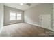 Bright bedroom featuring neutral walls, plush carpeting, and a window letting in natural light at 2305 Blueberry St, Belmont, NC 28012