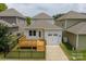 Charming single-Gathering home featuring a wooden deck, a one-car garage, and a well-maintained lawn with a black metal fence at 2305 Blueberry St, Belmont, NC 28012