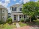 Charming two-story home featuring manicured landscaping, a welcoming front porch, and classic architectural details at 2305 Blueberry St, Belmont, NC 28012