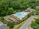 Aerial view of pool, playground, landscaping, clubhouse, street, and neighborhood at 2305 Blueberry St, Belmont, NC 28012