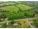 Aerial view shows the home's location amidst lush trees, green fields, and other residences at 2474 Cedar Valley Dr, Conover, NC 28613