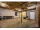 Unfinished basement with concrete floor and exposed ceiling, offering ample storage or customization at 2474 Cedar Valley Dr, Conover, NC 28613