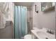 This traditional bathroom features a toilet, sink, and shower with a curtain, lit by a bright window at 2474 Cedar Valley Dr, Conover, NC 28613