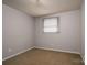 This carpeted bedroom features neutral paint and a single window, creating a serene and simple space at 2474 Cedar Valley Dr, Conover, NC 28613