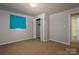 Simple bedroom featuring a neutral color scheme, a closet, and a window with blue curtains at 2474 Cedar Valley Dr, Conover, NC 28613
