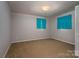 This cozy bedroom features neutral walls, carpeted floors, and is illuminated by natural light from two windows at 2474 Cedar Valley Dr, Conover, NC 28613