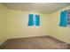 This bedroom is illuminated by natural light from its windows and features neutral carpet at 2474 Cedar Valley Dr, Conover, NC 28613
