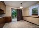 Bright dining area with access to the outdoor deck, accented by a window with patterned curtains at 2474 Cedar Valley Dr, Conover, NC 28613