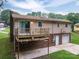 Rear exterior showing deck, garage, brick and side yard at 2474 Cedar Valley Dr, Conover, NC 28613