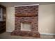 Close-up of a classic brick fireplace with a wooden mantel and a brick hearth at 2474 Cedar Valley Dr, Conover, NC 28613