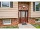 A close-up of the front door with brick accents and sidelight windows at 2474 Cedar Valley Dr, Conover, NC 28613