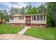 Charming split-level home featuring a brick facade, brown shutters, and a well-maintained lawn at 2474 Cedar Valley Dr, Conover, NC 28613