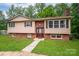 Split-level home with brick accents, shutters, and front lawn at 2474 Cedar Valley Dr, Conover, NC 28613