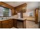 Kitchen featuring wooden cabinetry, tile countertops, and a built-in dishwasher at 2474 Cedar Valley Dr, Conover, NC 28613