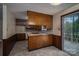 Functional kitchen area featuring wooden cabinetry and access to an outdoor deck space at 2474 Cedar Valley Dr, Conover, NC 28613