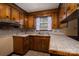 Well-lit kitchen featuring wooden cabinetry, tile countertops, and a window above the sink at 2474 Cedar Valley Dr, Conover, NC 28613