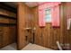Small laundry room with wood paneling and basic utility hookups at 2474 Cedar Valley Dr, Conover, NC 28613