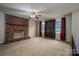 Cozy living room showcasing a brick fireplace, large windows, and neutral-toned walls and flooring at 2474 Cedar Valley Dr, Conover, NC 28613