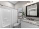 Bright bathroom featuring a granite countertop, decorative mirror, and a shower with a white curtain at 249 Landing Trl, Mount Gilead, NC 27306