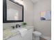 Well-lit bathroom with a granite countertop, black framed mirror and neutral wall color at 249 Landing Trl, Mount Gilead, NC 27306