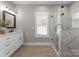 Modern bathroom with marble accents, glass shower and light filled window at 249 Landing Trl, Mount Gilead, NC 27306