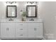 Elegant bathroom featuring a double vanity with marble countertops and framed mirrors at 249 Landing Trl, Mount Gilead, NC 27306