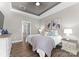 Comfortable bedroom featuring a decorative tray ceiling and ample natural light at 249 Landing Trl, Mount Gilead, NC 27306