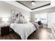 Primary bedroom with a tray ceiling, hardwood floors, and lots of natural light at 249 Landing Trl, Mount Gilead, NC 27306