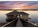 Waterfront boat dock with storage and lake access, perfect for boating and water activities at 249 Landing Trl, Mount Gilead, NC 27306