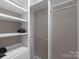 Organized walk-in closet with built-in shelving and hanging rods at 249 Landing Trl, Mount Gilead, NC 27306