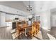 Dining room with a wooden table, chandelier, and open access to the modern kitchen at 249 Landing Trl, Mount Gilead, NC 27306