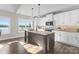 Bright kitchen featuring an island, shaker cabinets, modern appliances and a window view at 249 Landing Trl, Mount Gilead, NC 27306