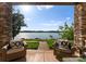 Stone patio with lake views, features comfortable seating, and access to beautiful outdoor space at 249 Landing Trl, Mount Gilead, NC 27306