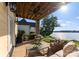 Covered patio with ceiling fan, featuring comfortable seating and a grill, perfect for outdoor living at 249 Landing Trl, Mount Gilead, NC 27306