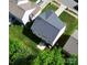 An aerial view showcases the home's roof, backyard with green grass, and trees surrounding the property at 3032 Mallard Forest Dr, Charlotte, NC 28269