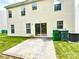 View of the backyard featuring a small patio, green lawn, and the exterior of the house at 3032 Mallard Forest Dr, Charlotte, NC 28269