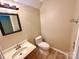 Half bath with hardwood style floors, a wooden vanity, and a white toilet at 3032 Mallard Forest Dr, Charlotte, NC 28269