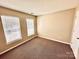 Bedroom featuring neutral walls, two windows, and brown carpet at 3032 Mallard Forest Dr, Charlotte, NC 28269