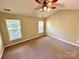 Bedroom featuring neutral walls, carpet, a ceiling fan, and two windows at 3032 Mallard Forest Dr, Charlotte, NC 28269