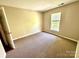 Cozy bedroom with neutral walls, carpet flooring, and a window allowing for natural light at 3032 Mallard Forest Dr, Charlotte, NC 28269