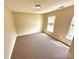 Bedroom featuring neutral walls, two windows, and brown carpet at 3032 Mallard Forest Dr, Charlotte, NC 28269