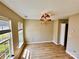Open dining room with hardwood floors, large window, and decorative chandelier at 3032 Mallard Forest Dr, Charlotte, NC 28269