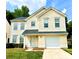 Charming yellow two-story home with a well-manicured lawn and attached one car garage at 3032 Mallard Forest Dr, Charlotte, NC 28269