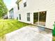 View of the backyard patio with a sliding glass door, a green lawn, and partial side view at 3032 Mallard Forest Dr, Charlotte, NC 28269